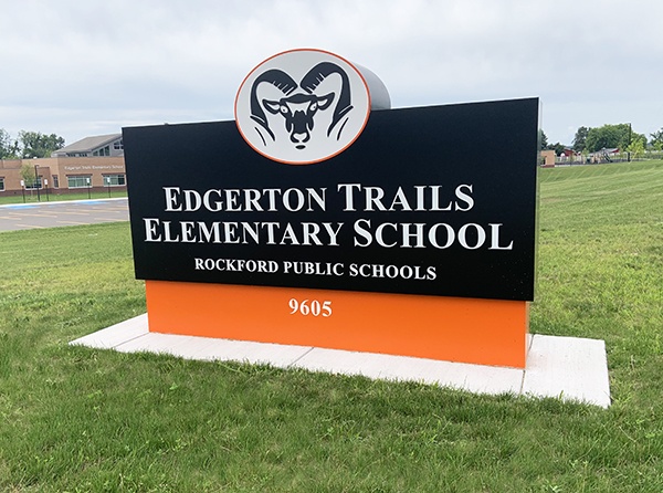 Edgerton Trails Elementary School Sign. Black and Orange rectangle with the Ram head logo at the top.